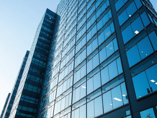 Modern office building exterior with glass facade and corporate signage, professional business environment